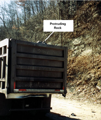 Photo showing truck with protruding rock