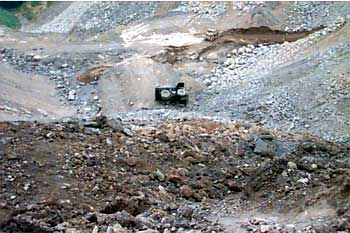 Photo showing haul truck at bottom of pit